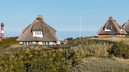 Foto, Häuser mit Reet-Dächern an der Küste