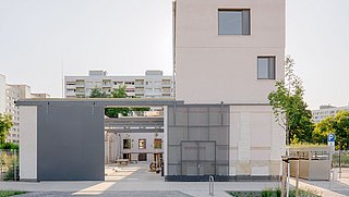 Foto, modernisiertes, kubisches Gebäude mit großen Fenstern und Garage in einer ruhigen Wohngegend.