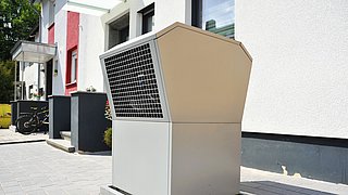 Foto, Luft-Luft-Wärmepumpe vor einem modernen Niedrigenergiehaus.