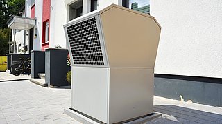 Foto, Luft-Luft-Wärmepumpe vor einem modernen Niedrigenergiehaus.