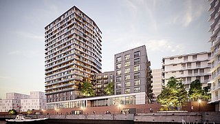 Foto, Mehrstöckiges Wohngebäude mit Balkonen am Wasser, umgeben von weiteren modernen Gebäuden, bei Dämmerung