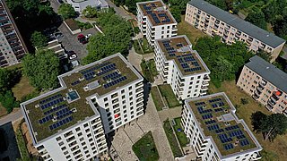 Foto, Luftbild von mehreren mehrstöckigen Gebäuden mit Gründächern und Solaranlagen.