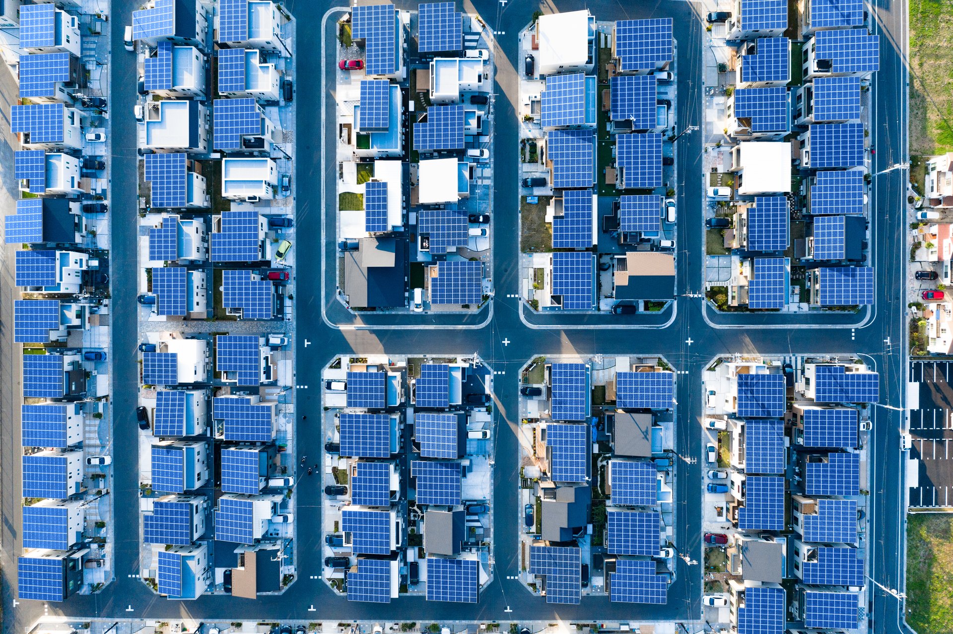 Foto, Luftaufnahme einer Siedlung, wobei auf jedem Dach eine Photovoltaikanlage platziert wurde.